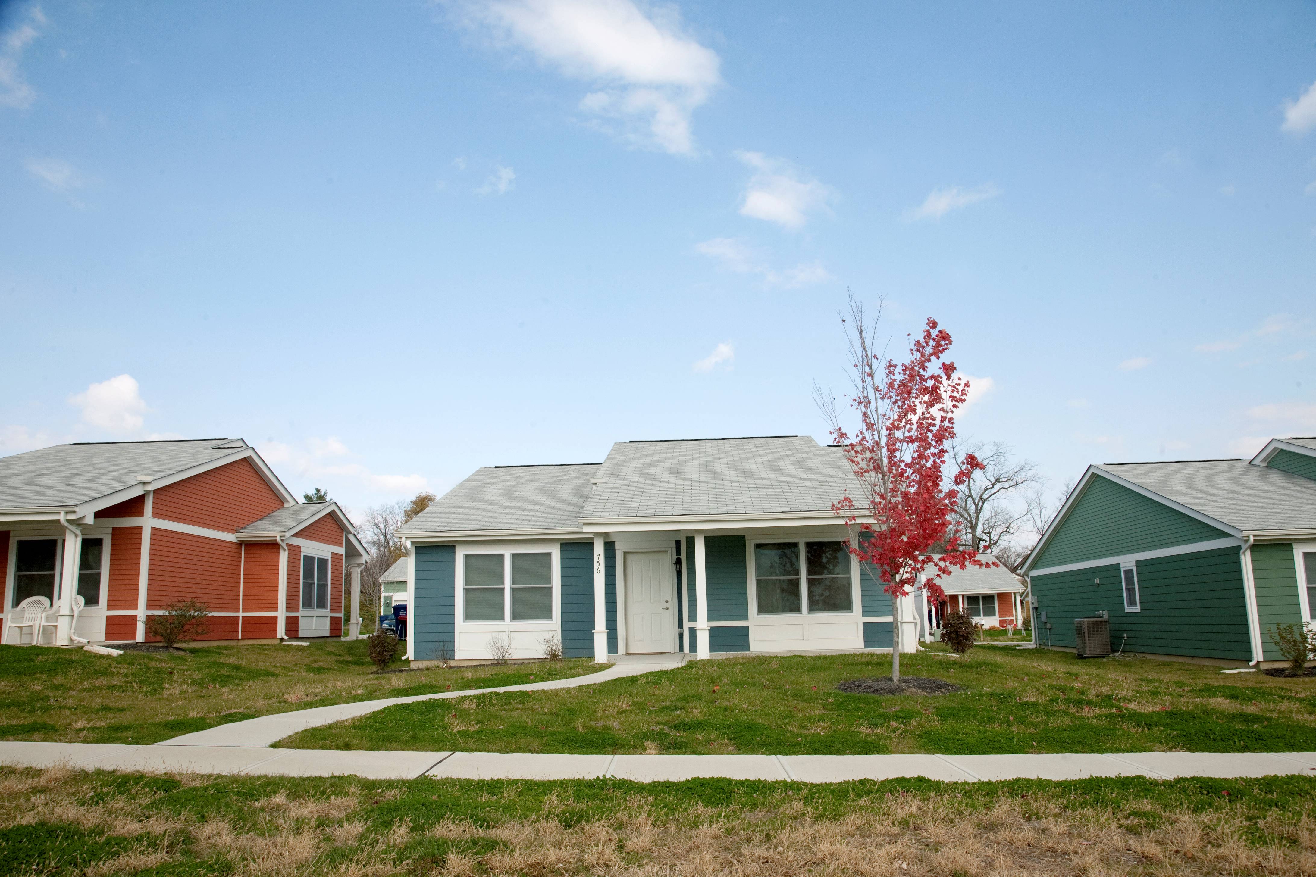 a row of houses in a neighborhood on a sunny day